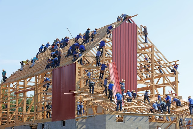 people building the wooden framework of a house